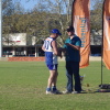 Tony Bishop receives his premiership medal from David Crough of Essential Energy