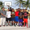Trust Company of the Marshall Is. Manager James Myazoe, second from left, and Marshall Islands Basketball Federation's Robert Pinho (right back) present the third place boys' high school trophy to Majuro Co-Op High School's team and coach Andrew Ward.