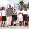 Trust Company of the Marshall Is. Manager James Myazoe, holding trophy, and Marshall Islands Basketball Federation's Robert Pinho (right back) present the girls' high school championship trophy to Majuro Co-Op High School's team and coach Andrew Ward.