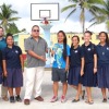 Trust Company of the Marshall Islands representative James Myazoe, holding trophy, and Marshall Islands Basketball Federation's Robert Pinho, right, present the girls' high school second place trophy to Majuro Baptist Christian Academy's team and coach.