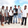 Marshall Islands Basketball Federation's Giff Johnson, second from right, presents the boys' championship trophy to Marshall Islands High School Coach Randon Kaneko (holding trophy, center), and the girls' third place trophy to coaches and MIHS staff.