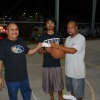 Sandy Alfred and tournament director Rickiano Antibas (right) congratulate Victor Navarro for winning a $50 free throw contest.