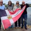 Bob, Gill, Kath and Clark with the burgee at the Pandora Inn on Restronguet Creek, Mylor Bridge (in Falmouth, South-West England, UK). The man who built it reputedly wrecked HMS Pandora on the Barrier Reef after being dispatched to bring home for trial th
