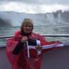 Susan Webber holds the Burgee at Niagara Falls, USA/Canadian border