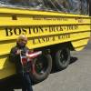 Susan Webber holds the Burgee in Boston, USA next to the land & water tour boat