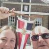 Sarah and David Wallace meeting up on the meridian line in Greenwich, UK with their burgee