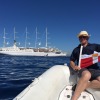 PC Mike Smith holds the burgee in front of Club Med 2 in Capri, Italy