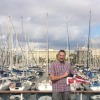 Andrew Middleton holds the burgee on the deck at the Reial Club Nàutic de Barcelona (Royal Barcelona Maritime Club).