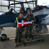 PC Mike Smith holds the Burgee at the RAAF base in Williamtown, preparing to go for a flight in a Hawk jet.