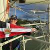 Mary Kerr holds the burgee on the top platform of the main mast on the Tall Ship 'Tenacious', whilst berthed at Nelson, New Zealand.