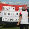 80 year old Stephanie approaches the banner