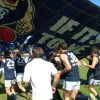 Players running through the banner