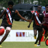 A NT players is all poise and balance as he's about to send his team into attack v Queensland.