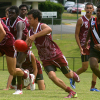A young Murri breaks with the ball for Queensland.
