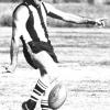 Neil Rutzou clearing from the centre for Tamworth.  Dated 1982, courtesy of the Northern Daily Leader.