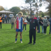 Under-18 captain Riley Hogarth and coach Kristian Gray raise the trophy