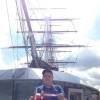 David Wallace with the burgee in front of the Cutty Sark, Greenwich, UK